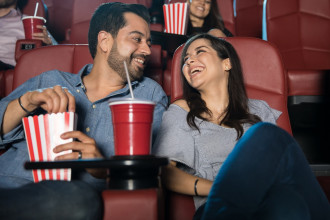 Happy couple laughing together in a movie theater