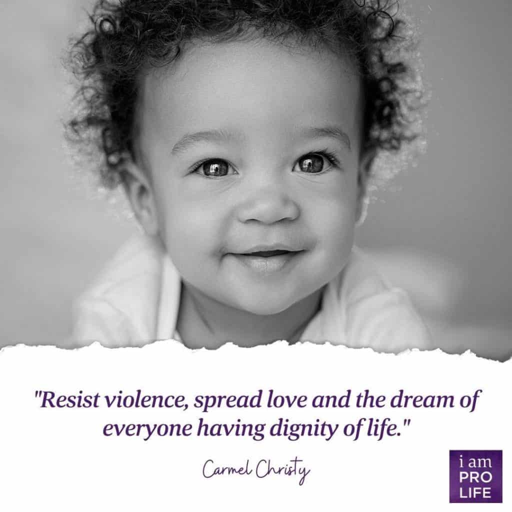 A baby boy with a quote on resisting violence for the March for life 2021