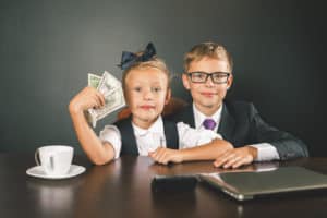 boy and girl with money, laptop