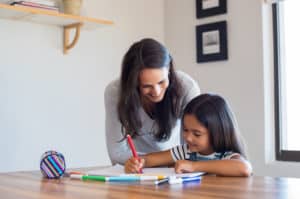 woman helping young girl