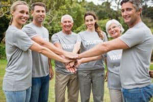 volunteers put hands together