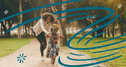 Mom teaching son life skills, such as how to ride a bike