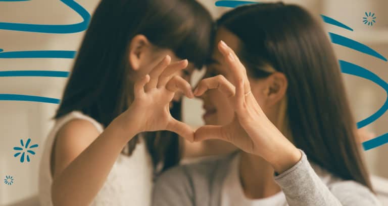 Mother and daughter making a heart with their hands