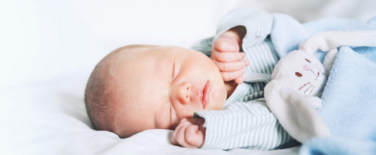 Close-up of infant boy sleeping on his side