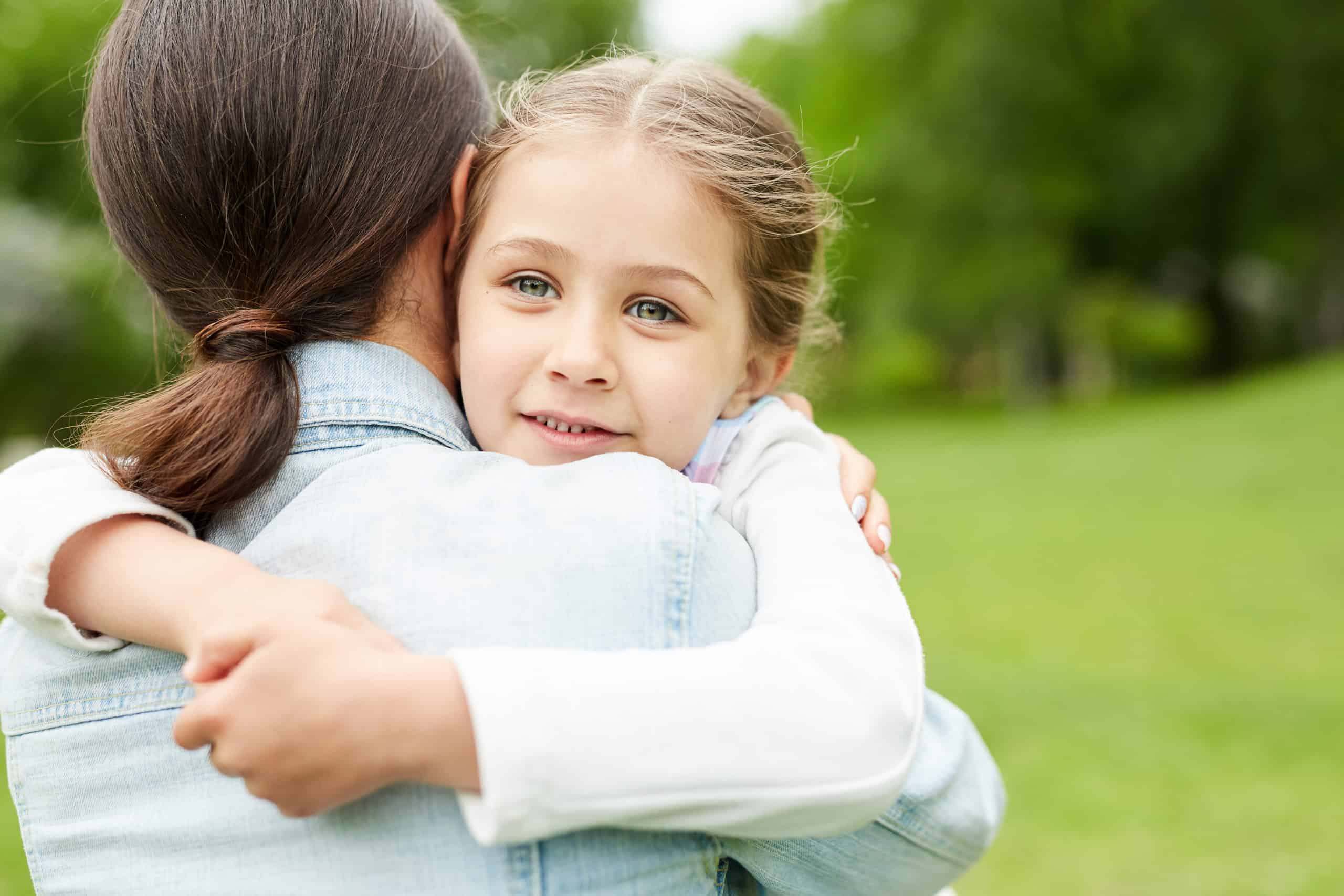 foster mom hugging little girl