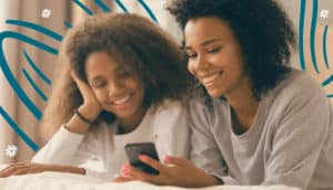 Mom and daughter laughing at a funny parenting meme