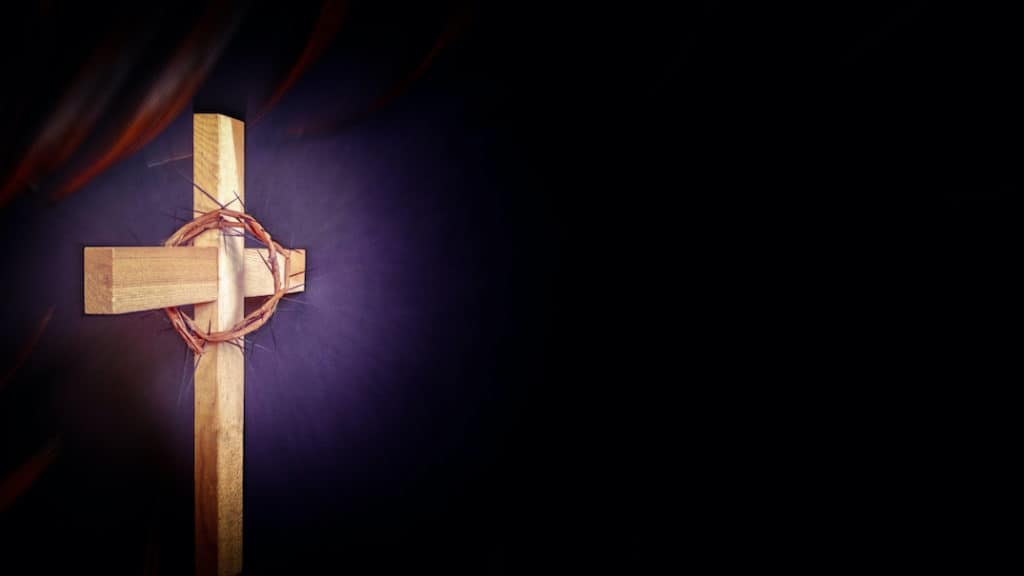 An illustration of a cross with a crown of thorns on a purple background.