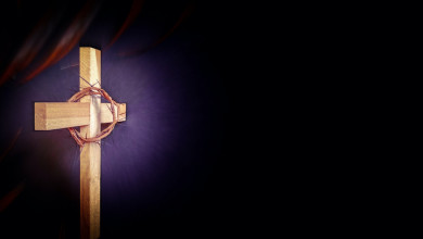 An illustration of a cross with a crown of thorns on a purple background.