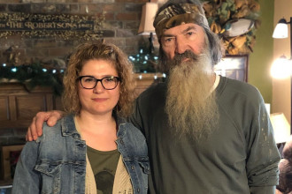 Phil Robertson and his daughter Phyllis posing for a photo