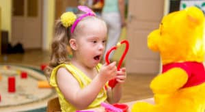 Girl with Down syndrome playing