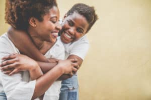 child with trauma hugging mom