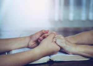 couple praying over first foster placement