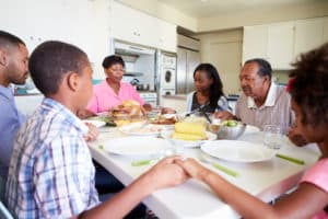 Multi-Generation Family Saying Prayer at table