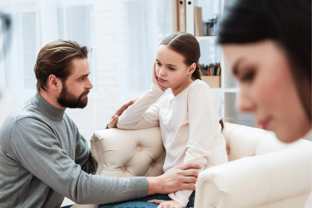 creating security in difficult times begins with being honest with your children. Father having a heart to heart talk with his little girl sitting on the couch