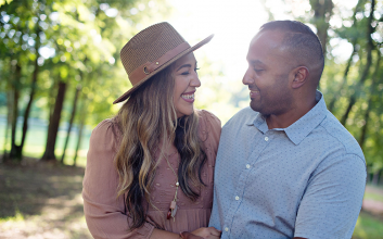 gratitude-A husband and wife smiling at one another, holding each other close.