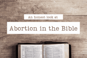 A Bible open on a wooden table with the title Abortion in the Bible.