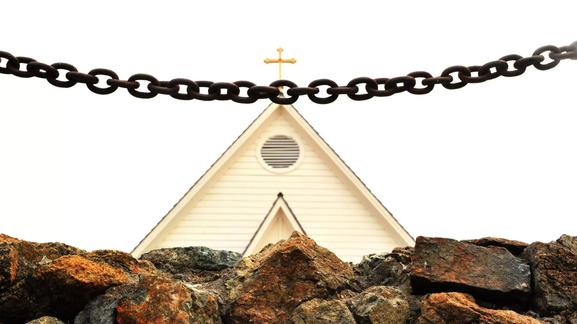 Photo of a wall and chain between the viewer and the church, symbolizing spiritual abuse keeping you away from God.