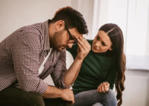 Man has mental health issues, his wife is consoling him.