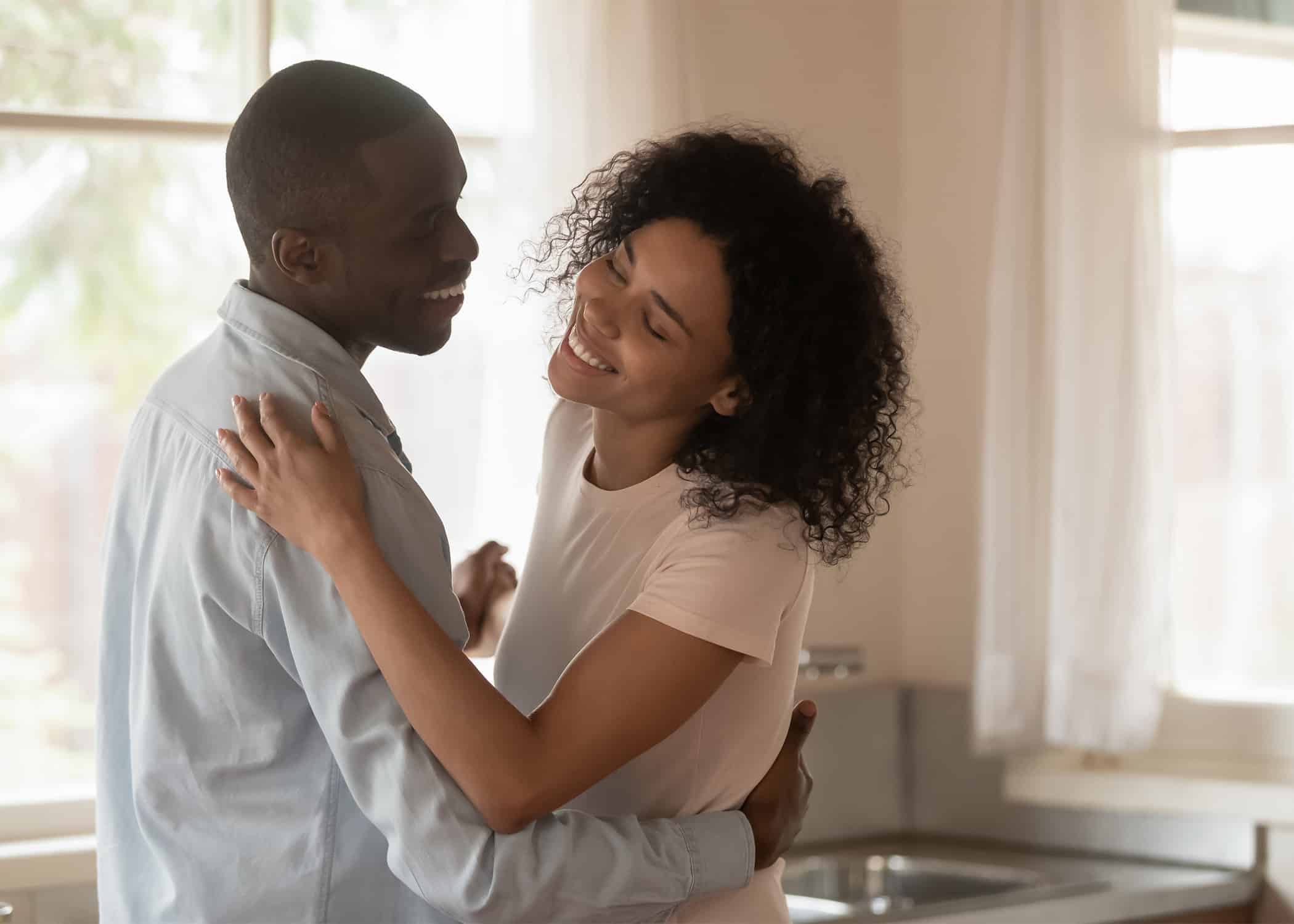 Happy-young-African-American-couple-dancing-in-living-room