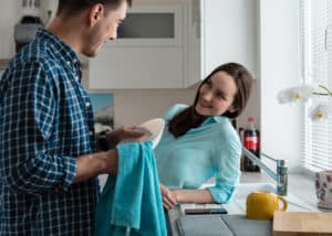 couple-in-kitchen-talking-while-doing-dishes