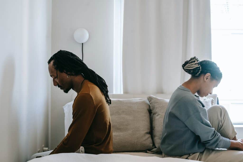 Man and woman sitting back to back