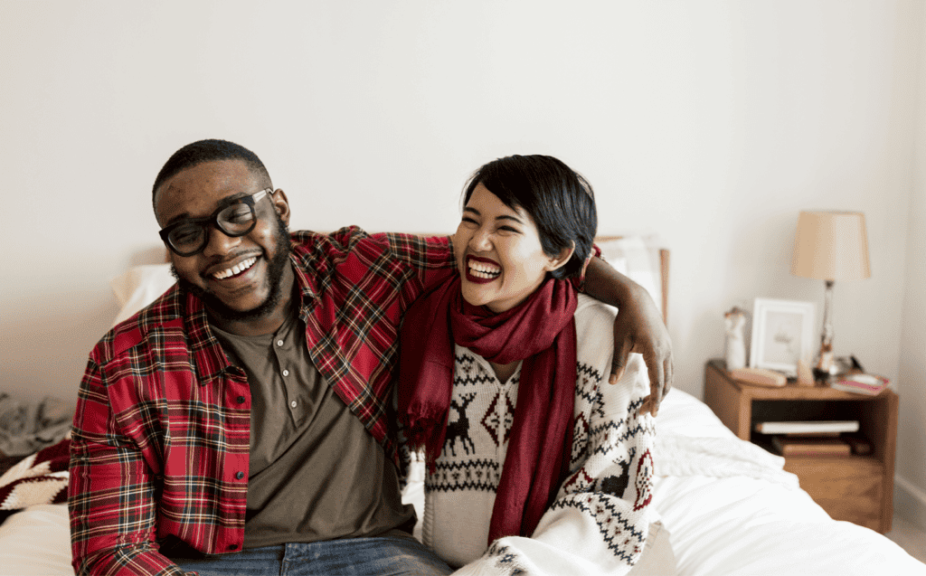 Expectations About Giving: Cheerful couple enjoying Christmas holiday