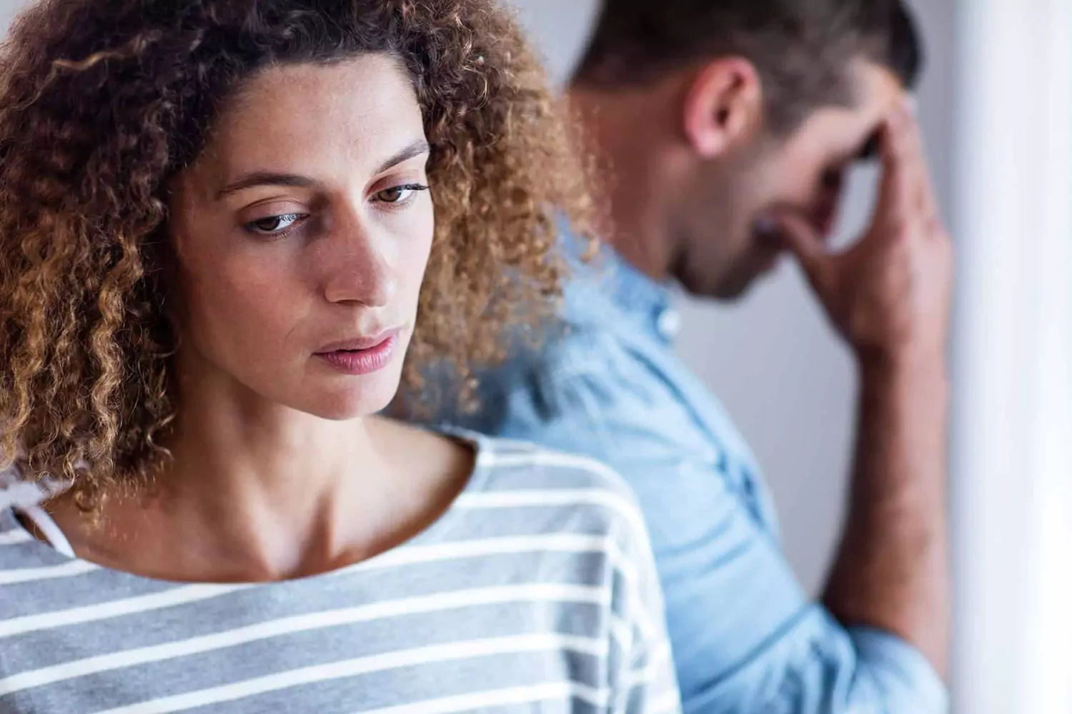 unhappy-woman-with-man-in-the-background