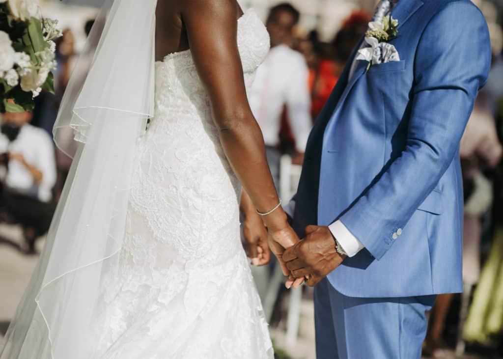 Black-couple-holding-hands-during-wedding-ceremony