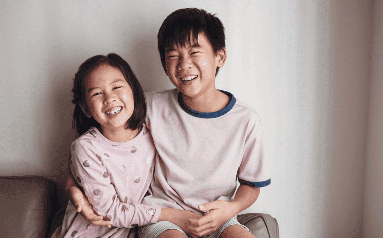 Laughing Asian little brother and sister at home, Happy children portrait