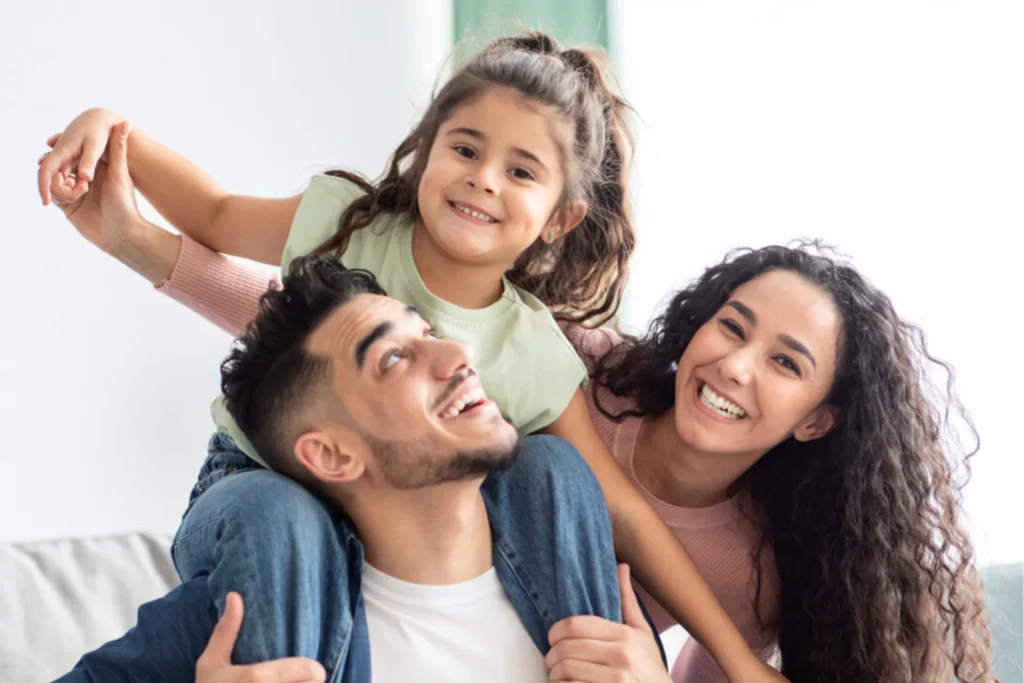 family playing happily together on a couch