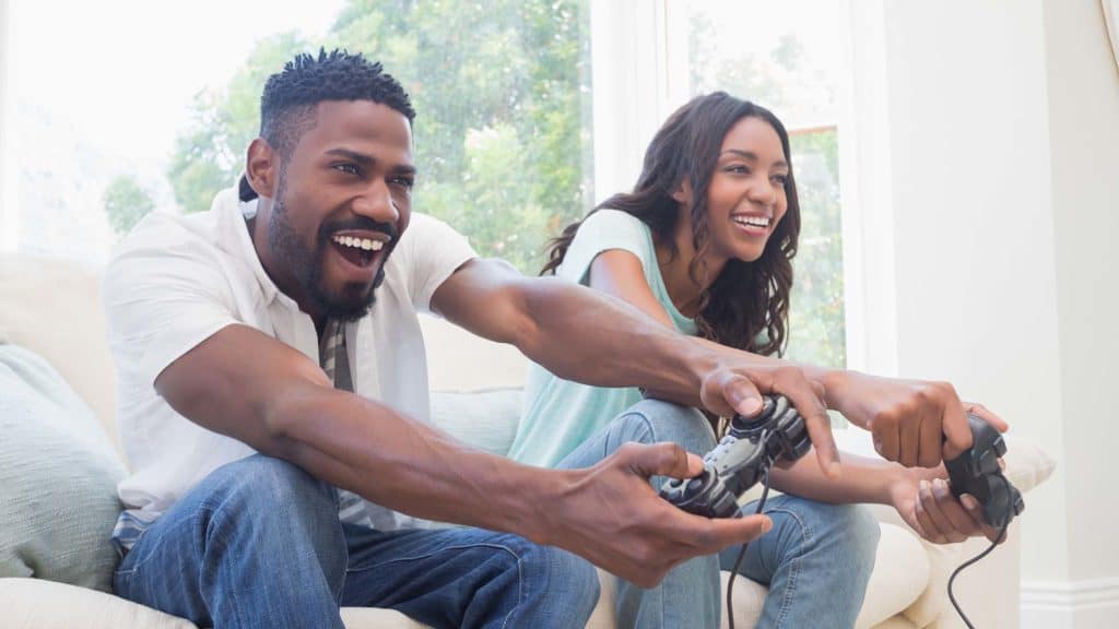 Happy young couple playing a video game