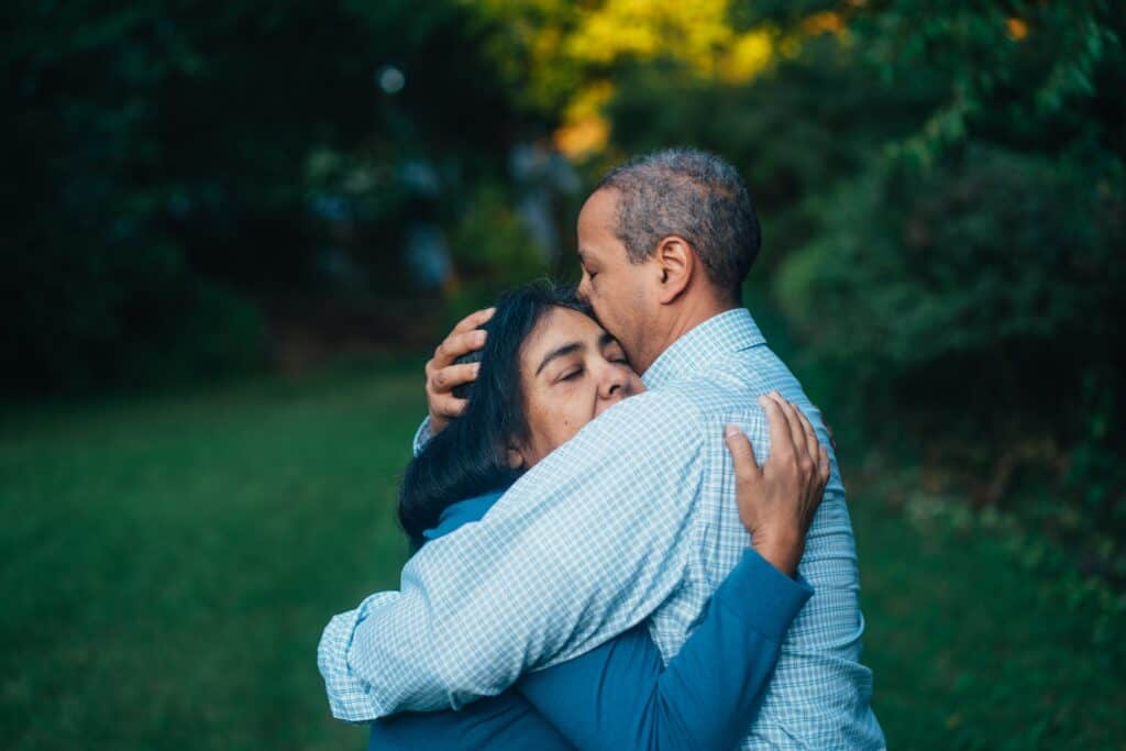 Tired and sad husband and wife embracing