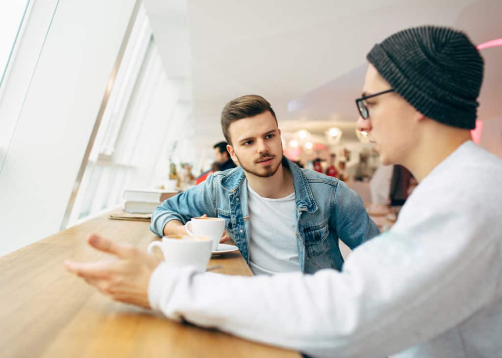 Two-men-having-serious-talk-in-coffee-shop