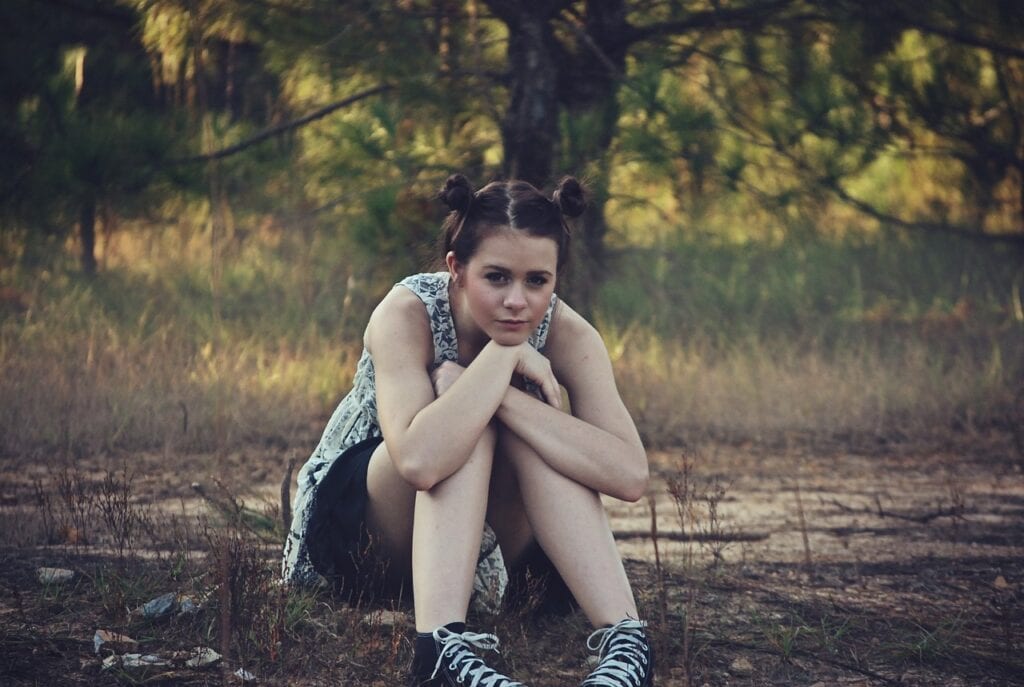 girl leaning over unhappy