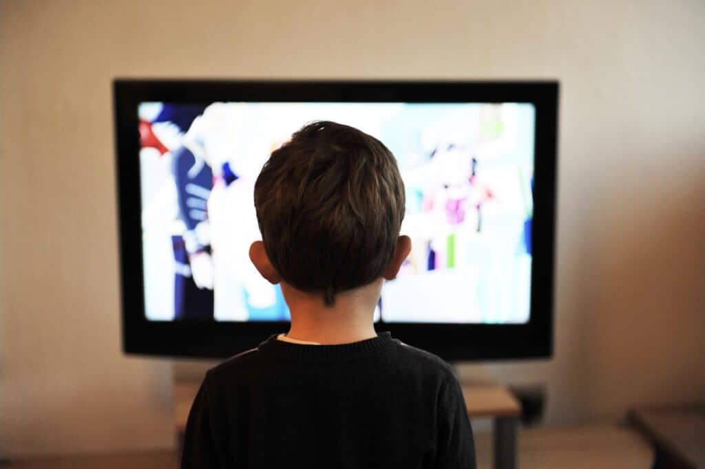 back of child's head staring at screen