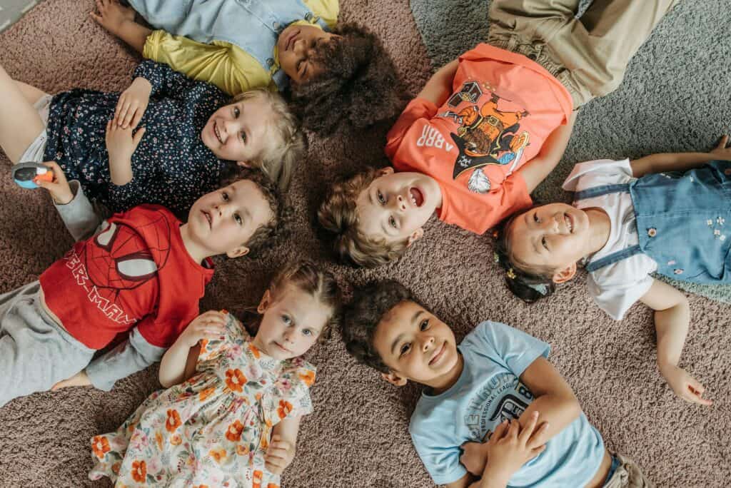 kids lying with heads in the middle on carpet