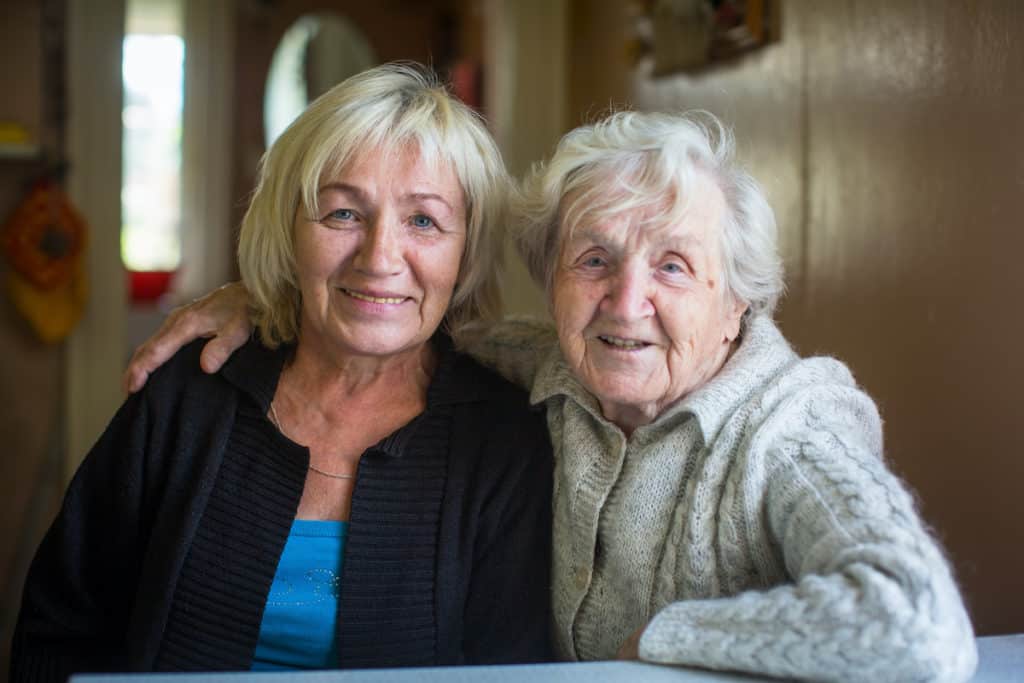 An elderly woman with her adult daughter.