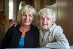 An elderly woman with her adult daughter.