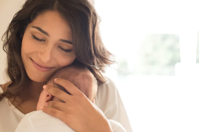 beautiful woman holding a newborn