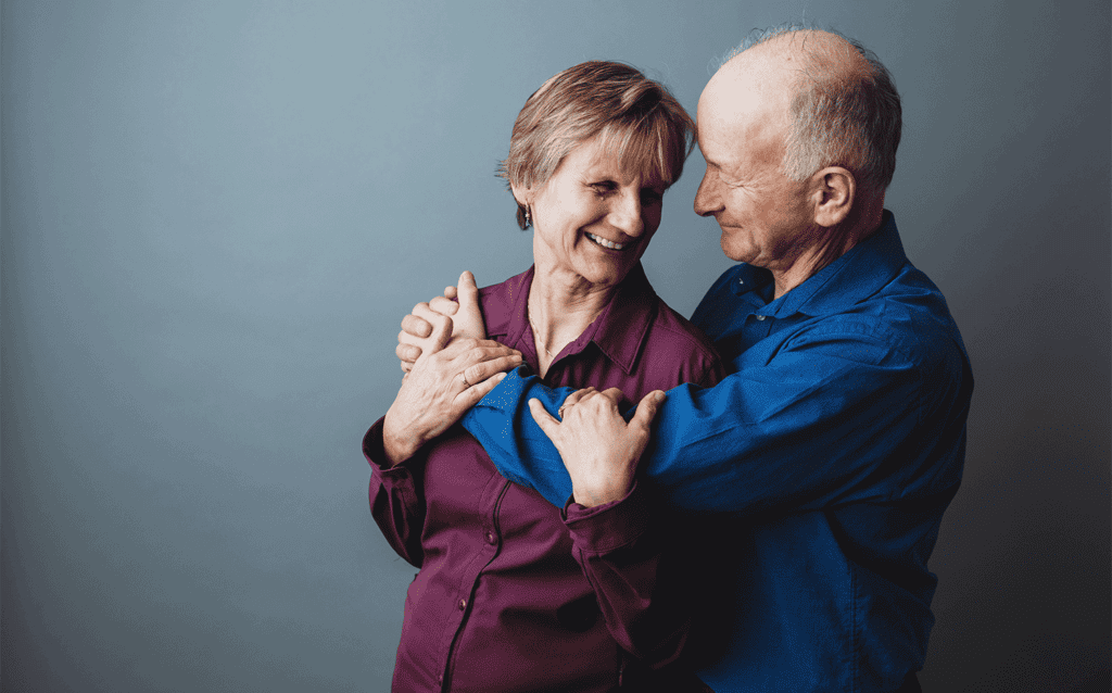 surviving marriage difficulties - Denis and Joyce embracing one another and smiling