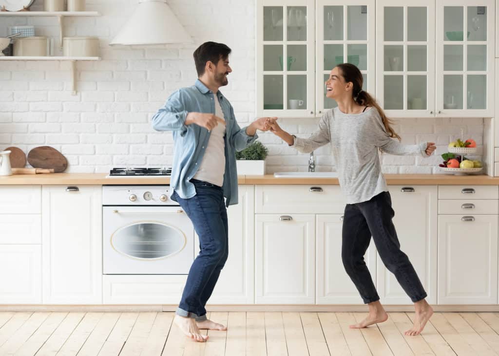 Happy-couple-having-fun-dancing-together-in-modern-kitchen