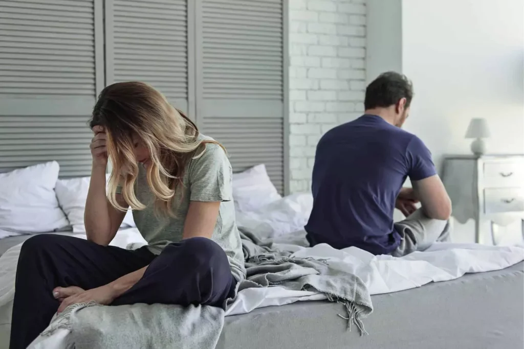 Unhappy-married-couple-sitting-on-bed-not-facing-each-other