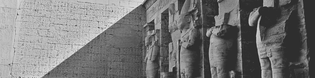 A black and white photo of Egyptian statues referencing the appearance of abortion in ancient Egypt