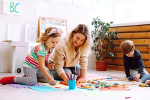 Mom painting with her children, demonstrating that ADHD in kids can be addressed in ways that help children thrive.