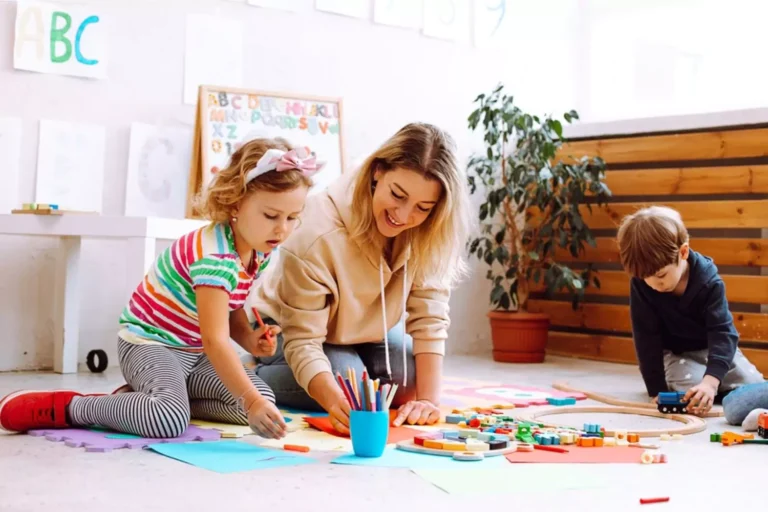 Mom painting with her children, demonstrating that ADHD in kids can be addressed in ways that help children thrive.
