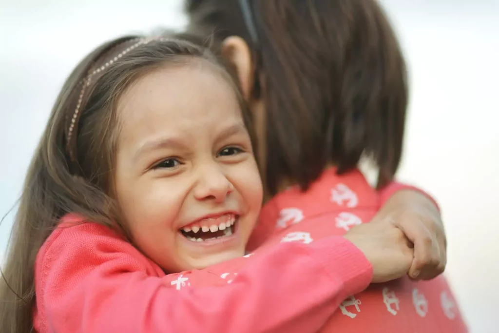 disciplining children, young girl with a big hugging her mother