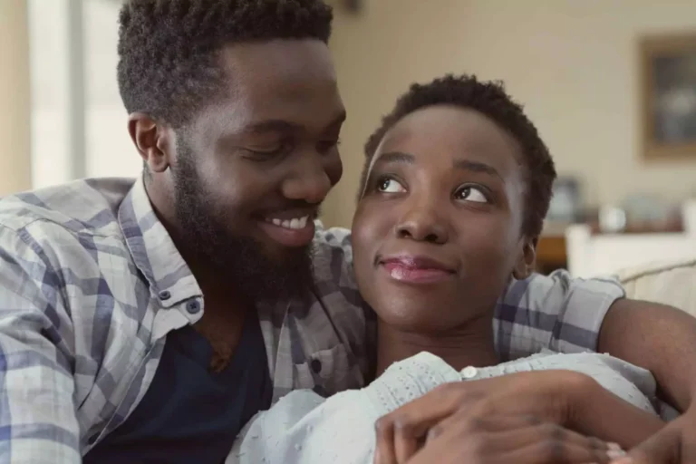 A couple sitting close together at home, showing warmth and affection, reflecting emotional tension around the topic “I want another baby but my husband doesn’t.”