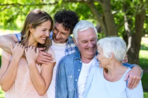 Relating to your-inlaws can be tough. This photo shows a young couple smiling harmoniously with their in-laws.