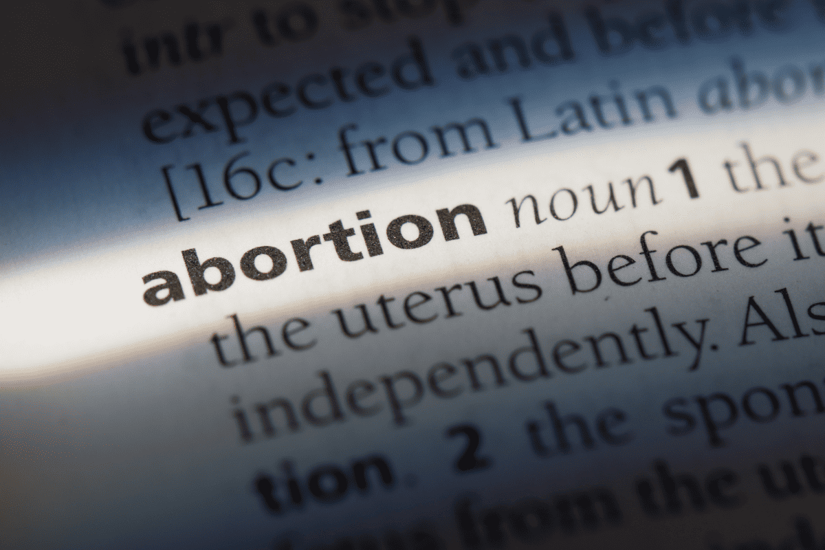 A page containing the definition of abortion and abortion history highlighted by light.