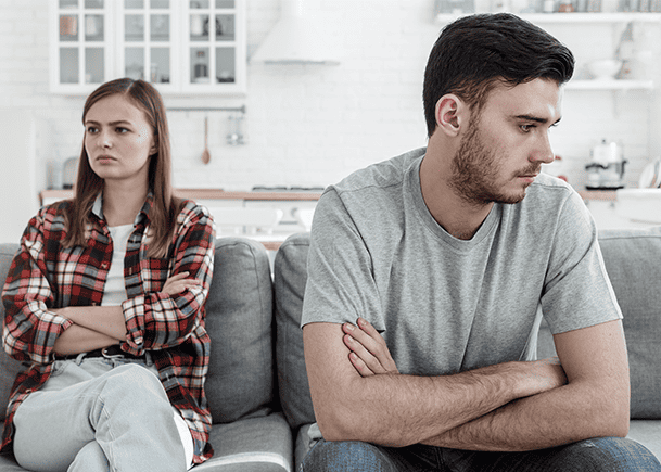Unhappy-married-couple-sitting-on-couch-not-looking-at-each-other